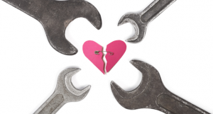 wrenches surrounding broken heart